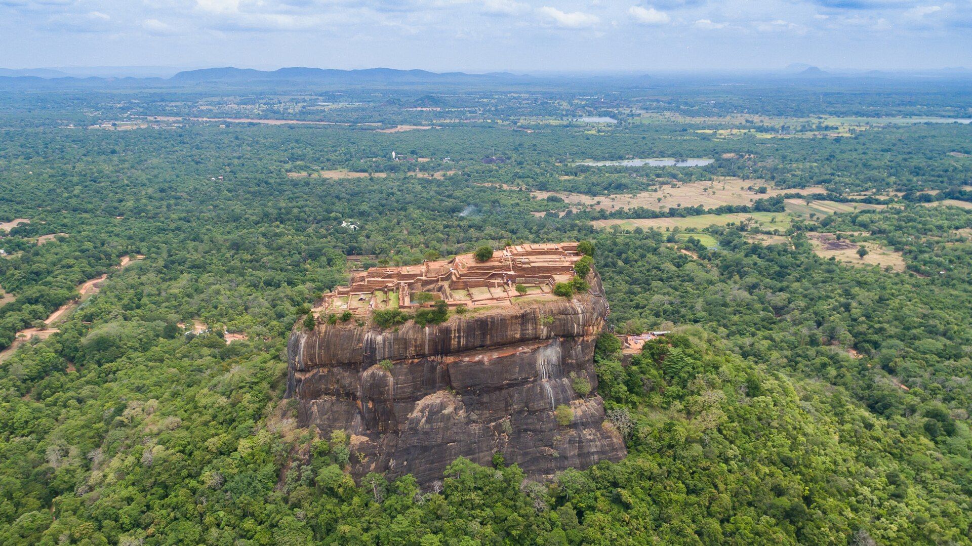 Aerial view of Sigiriya rock fortress rising above the jungle